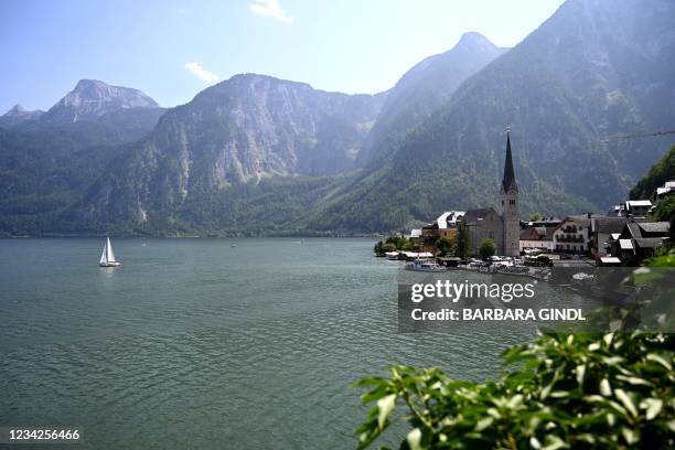 Photo taken on July 21, 2021 shows the town of Hallstatt on Lake Hallstatt with the Evangelical Church at its centre, Upper Austria. - State...