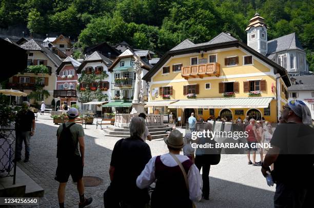 Tourists visit the town of Hallstatt, Upper Austria, on July 21, 2021. - State elections in Upper Austria will take place on September 26, 2021. -...