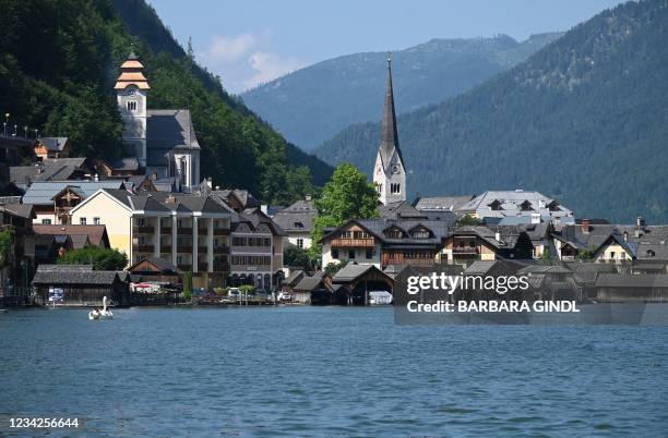 Photo taken on July 21, 2021 shows the town of Hallstatt on Lake Hallstatt with the Evangelical Church at its centre, Upper Austria. - State...