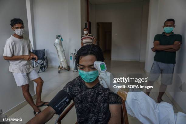 Isolated patients get their routine medical check up at Wisma Bima Cottages II, Kuta. Bali local government has centralized Covid-19 isolations for...