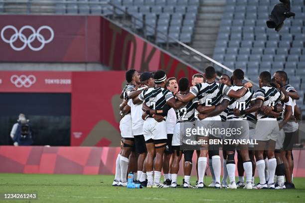 Fiji's players celebrate winning the men's final rugby sevens match between New Zealand and Fiji during the Tokyo 2020 Olympic Games at the Tokyo...