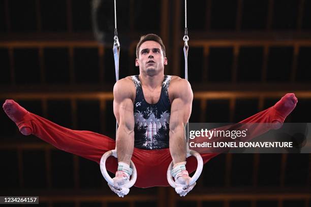 S Samuel Mikulak competes in the rings event of the artistic gymnastics men's all-around final during the Tokyo 2020 Olympic Games at the Ariake...