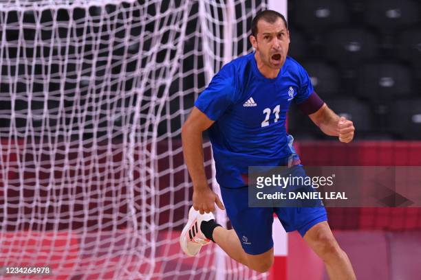 France's wing Michael Guigou celebrates after scoring during the men's preliminary round group A handball match between France and Germany of the...