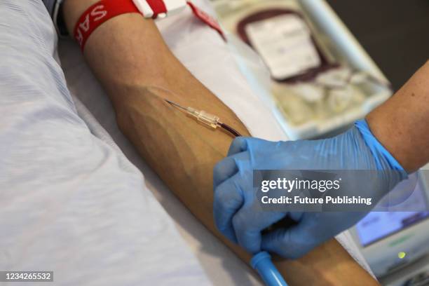Healthcare worker places a catheter during the blood donation procedure in Kyiv, capital of Ukraine.