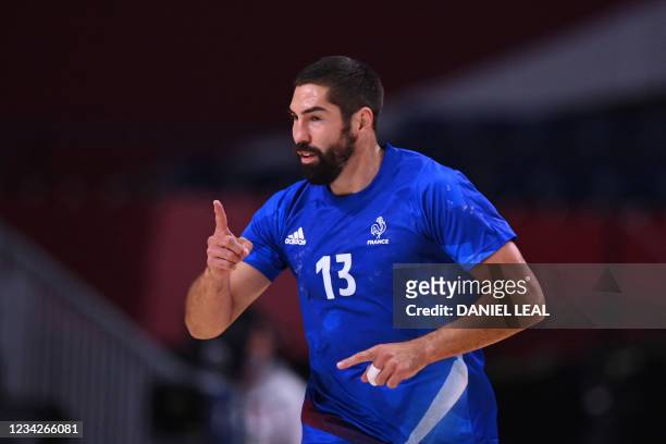 France's centre back Nikola Karabatic celebrates after scoring during the men's preliminary round group A handball match between France and Germany...