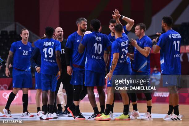 France's players celebrate their victory after during the men's preliminary round group A handball match between France and Germany of the Tokyo 2020...