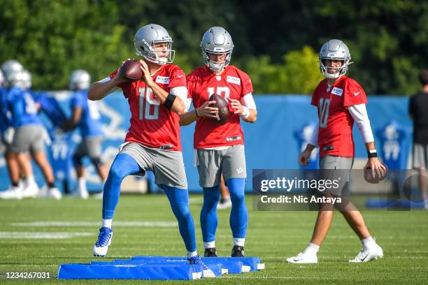 Jared Goff, Tim Boyle and David Blough of the Detroit Lions run a drill during the Detroit Lions Training Camp on July 28, 2021 in Allen Park,...