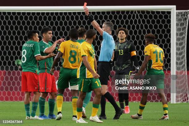 New Zealand referee Matt Conger shows a red card to Mexico's midfielder Carlos Rodriguez during the Tokyo 2020 Olympic Games men's group A first...