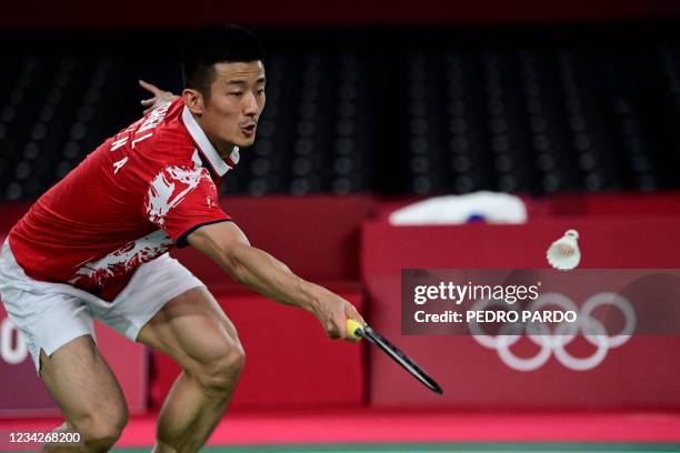 China's Chen Long hits a shot to Spain's Pablo Abian in their men's singles badminton group stage match during the Tokyo 2020 Olympic Games at the...