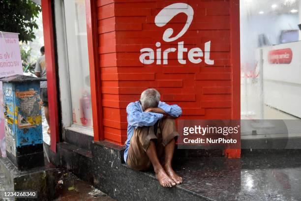 Man sleeps in front of an Airtel store in Kolkata, India, 28 July, 2021. Bharti Airtel share price jumps 5%. The telecom giants stock was trading at...