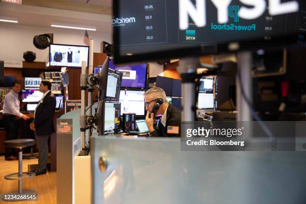 Traders work on the floor of the New York Stock Exchange in New York, U.S., on Wednesday, July 28, 2021. U.S. Futures drifted and stocks were mixed...