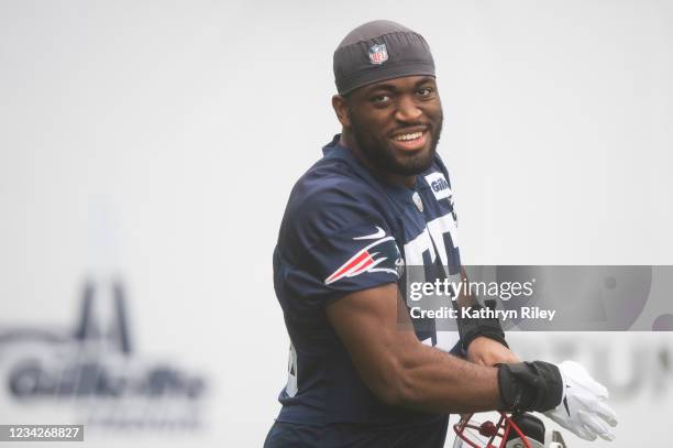 Josh Uche of the New England Patriots walks onto the field during training camp at Gillette Stadium on July 28, 2021 in Foxborough, Massachusetts.