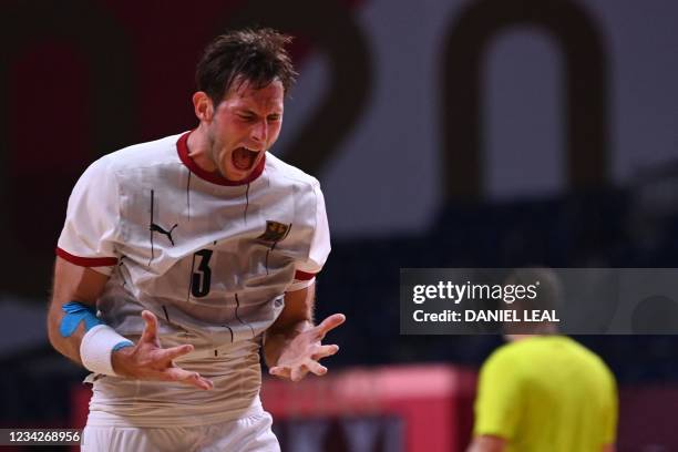 Germany's let wing Uwe Gensheimer reacts after being defeated by France at the end of the men's preliminary round group A handball match between...