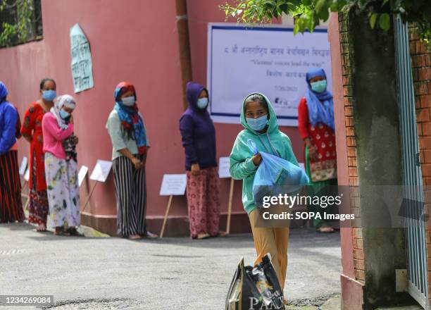 Sex worker carries a food bag provided by "Maiti Nepal", a non-profit organization in Nepal dedicated to help the victims of human trafficking and...