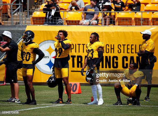 Cameron Sutton, Dwayne Haskins, Joe Haden and Arthur Maulet of the Pittsburgh Steelers look on during training camp at Heinz Field on July 28, 2021...