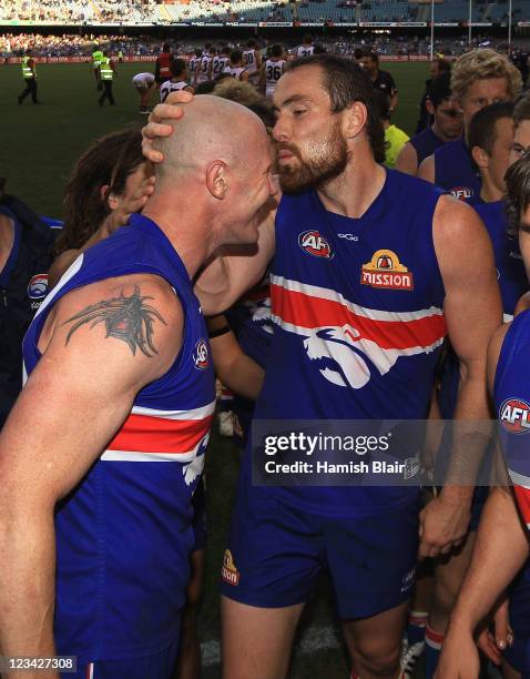 Retiring player Barry Hall of the Bulldogs is kissed by fellow retiring team mate Ben Hudson after the round 24 AFL match between the Western...