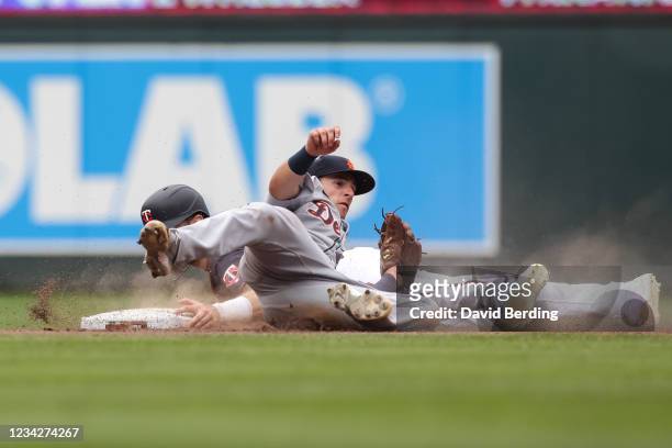 Jake Cave of the Minnesota Twins is caught trying to steal second base by Zack Short of the Detroit Tigers in the eighth inning of the game at Target...