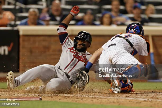 James McCann of the New York Mets tags out Abraham Almonte of the Atlanta Braves attempting to score a run during the ninth inning at Citi Field on...