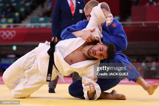 Canada's Shady Elnahas and United Arab Emirates's Ivan Remarenco compete in the judo men's -100kg elimination round bout during the Tokyo 2020...