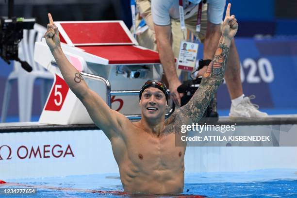 S Caeleb Dressel celebrates winning to take gold in the final of the men's 100m freestyle swimming event during the Tokyo 2020 Olympic Games at the...