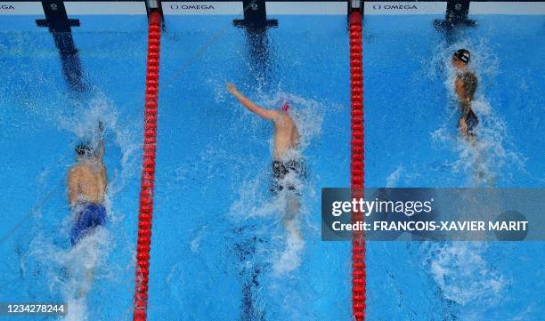 An overview shows USA's Caeleb Dressel as he wins ahead of Russia's Kliment Kolesnikov and Italy's Alessandro Miressi in the final of the men's 100m...