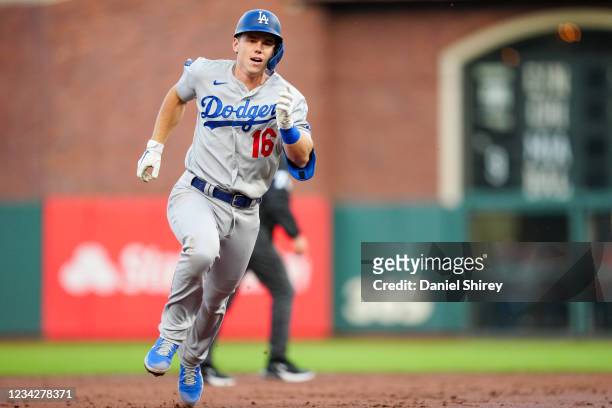 Will Smith of the Los Angeles Dodgers heads to third after hitting a two RBI triple during the game between the Los Angeles Dodgers and the San...