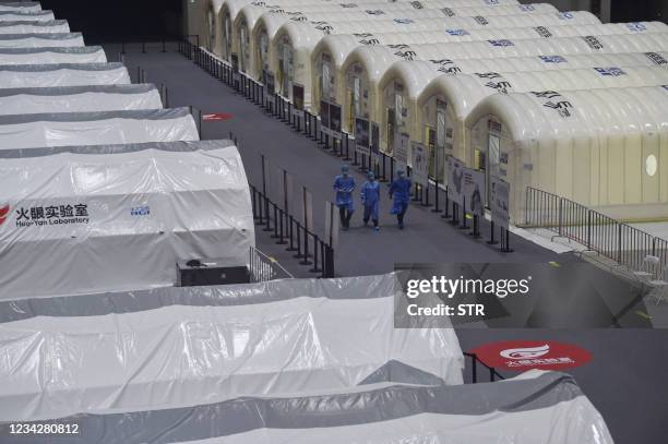 This photo taken on July 28, 2021 shows a temporary "Fire Eye" laboratory used for Covid-19 coronavirus testing at an exhibition centre in Nanjing in...