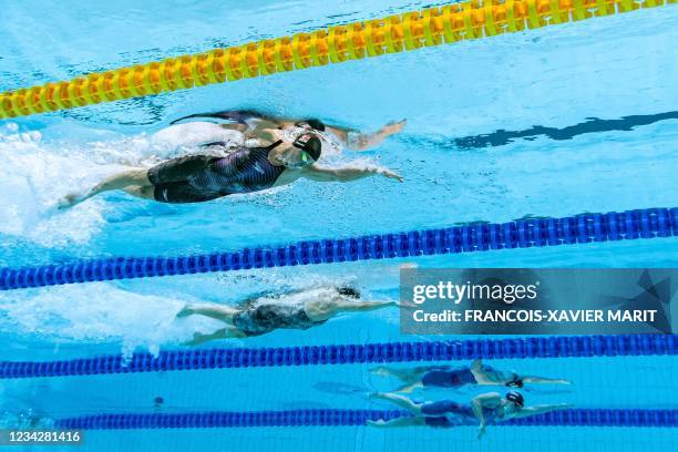 An underwater view shows Denmark's Pernille Blume Denmark's Signe Bro and USA's Erika Brown in a semi-final of the women's 100m freestyle swimming...