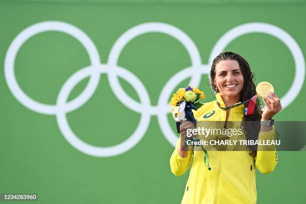 Australia's Jessica Fox poses with her gold medal on the podium following the women's Canoe final during the Tokyo 2020 Olympic Games at Kasai Canoe...