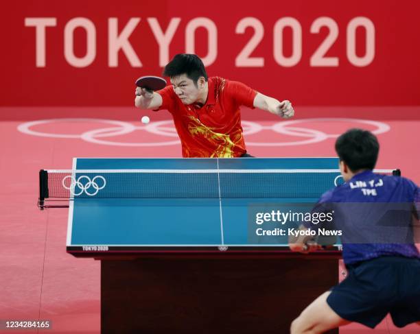 China's Fan Zhendong plays against Taiwan's Lin Yun-ju in the men's table tennis singles semifinals at the Tokyo Olympics on July 29 at Tokyo...