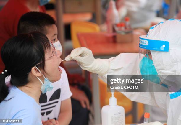 Medical staff take samples for nucleic acid testing at the nucleic acid testing site of Nanjing No.29 Middle School Shogunate Branch in Nanjing,...