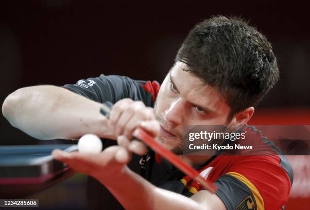 Germany's Dimitrij Ovtcharov serves during his semifinal match of the Tokyo Olympic men's table tennis singles tournament against China's Ma Long on...