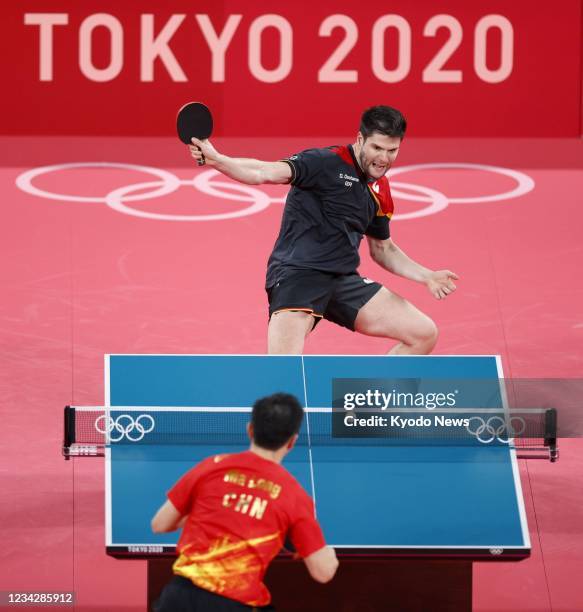 Germany's Dimitrij Ovtcharov plays against China's Ma Long in his semifinal match of the Tokyo Olympic men's table tennis singles tournament on July...