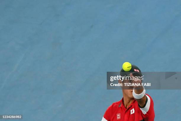Japan's Kei Nishikori serves to Serbia's Novak Djokovic during their Tokyo 2020 Olympic Games men's singles quarterfinal tennis match at the Ariake...