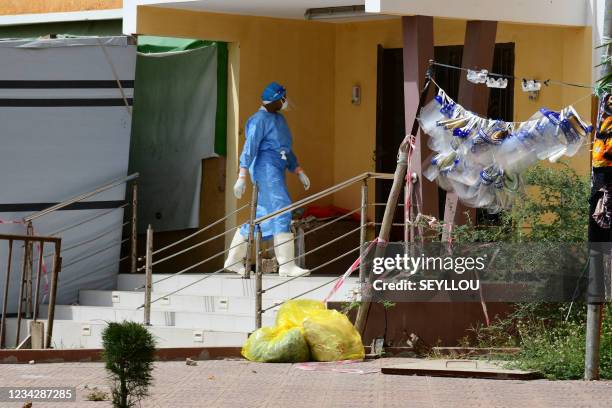 Health worker wearing personal protective gear is seen at the Idrissa Pouye de Grand Yoff Hospital, on July 28, 2021. - In the West African country's...