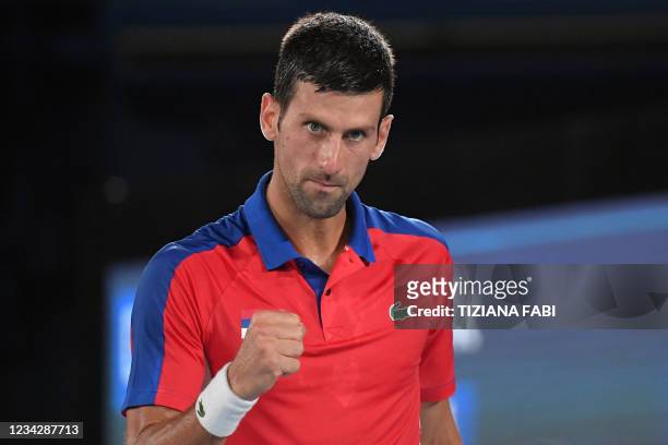 Serbia's Novak Djokovic celebrates during his Tokyo 2020 Olympic Games men's singles quarterfinal tennis match against Japan's Kei Nishikori at the...