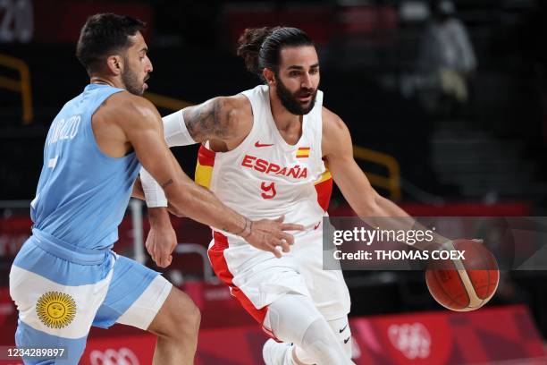 Spain's Ricky Rubio dribbles the ball past Argentina's Facundo Campazzo in the men's preliminary round group C basketball match between Spain and...