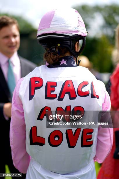 General view of a Peace and Love message on the silks of jockey Goose Leigh prior to riding in the Magnolia Cup during day three of the Goodwood...