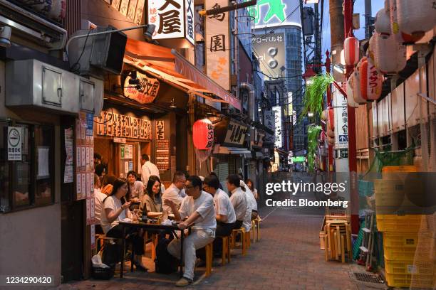 Customers at a bar in the Shinjuku district of Tokyo, Japan, on Thursday, July 29, 2021. While the number of infections directly connected with the...