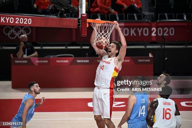 Spain's Pau Gasol Saez dunks the ball past in the men's preliminary round group C basketball match between Spain and Argentina during the Tokyo 2020...