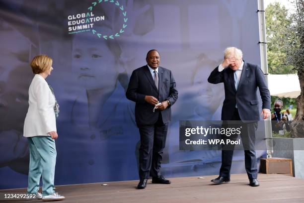 Britain's Prime Minister Boris Johnson poses with Kenya's President Uhuru Kenyatta and Australia's former prime minister Julia Gillard as he arrives...