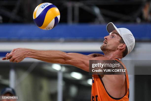 Netherlands' Robert Meeuwsen digs the ball in their men's preliminary beach volleyball pool D match between Brazil and the Netherlands during the...