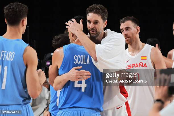 Argentina's Luis Scola and Spain's Pau Gasol Saez embrace at the end of the men's preliminary round group C basketball match between Spain and...