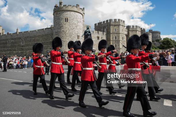 The Old Guard from the 1st Battalion Grenadier Guards leaves Windsor Castle following the Changing of the Guard ceremony on 29th July 2021 in...
