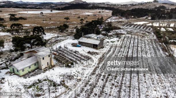 July 2021, Brazil, Sao Joaquim-Urupema: Snow lies over the fields after a cold front caused it to snow in more than ten cities in the southern state....