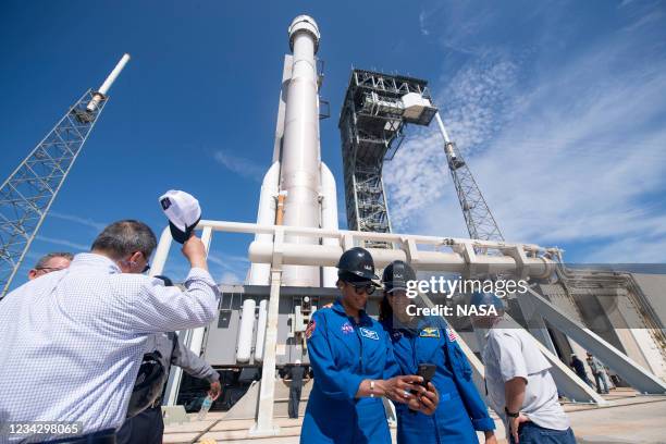 In this NASA handout, NASA astronauts Jeanette Epps, left, and Suni Williams, right, take a selfie as a United Launch Alliance Atlas V rocket with...