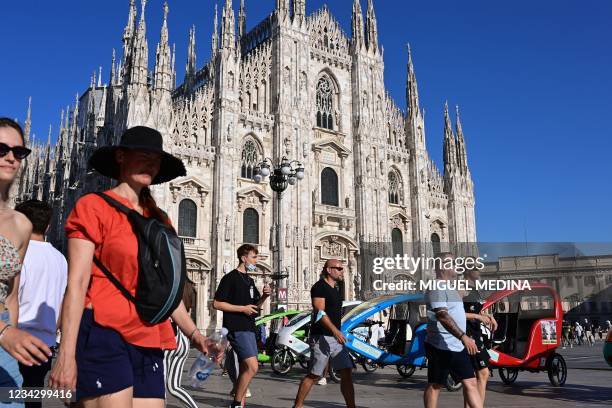 Picture taken on July 29, 2021 shows tourists and inhabitants strolling in Duomo Square in center Milan.