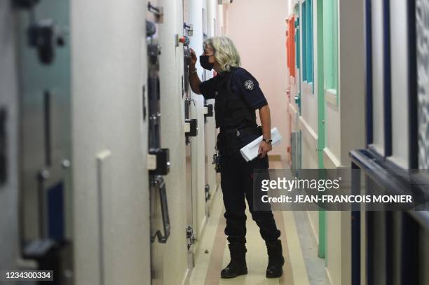 Prison warden looks inside a cell at the new prison unit aimed at separating women prisoners who have been assessed to be a risk of radicalising...