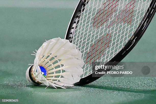 China's He Bingjiao picks up the shuttlecock with her racket between points with Japan's Nozomi Okuhara in their women's singles badminton quarter...