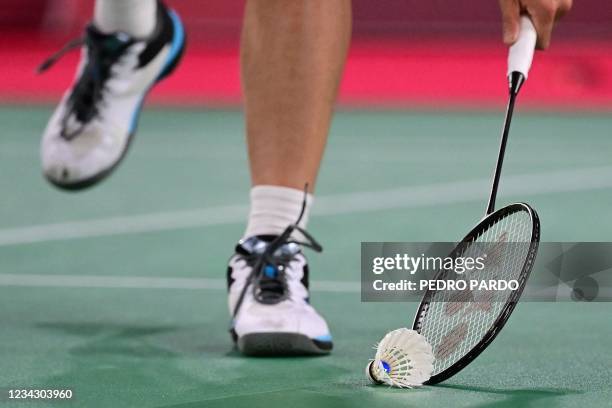 China's He Bingjiao picks up the shuttlecock with her racket between points with Japan's Nozomi Okuhara in their women's singles badminton quarter...